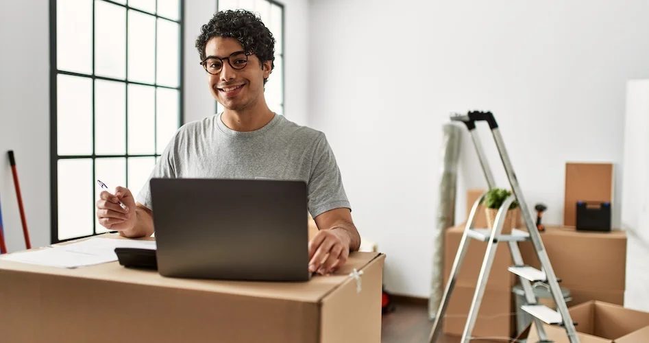 man calculating moving costs on computer
