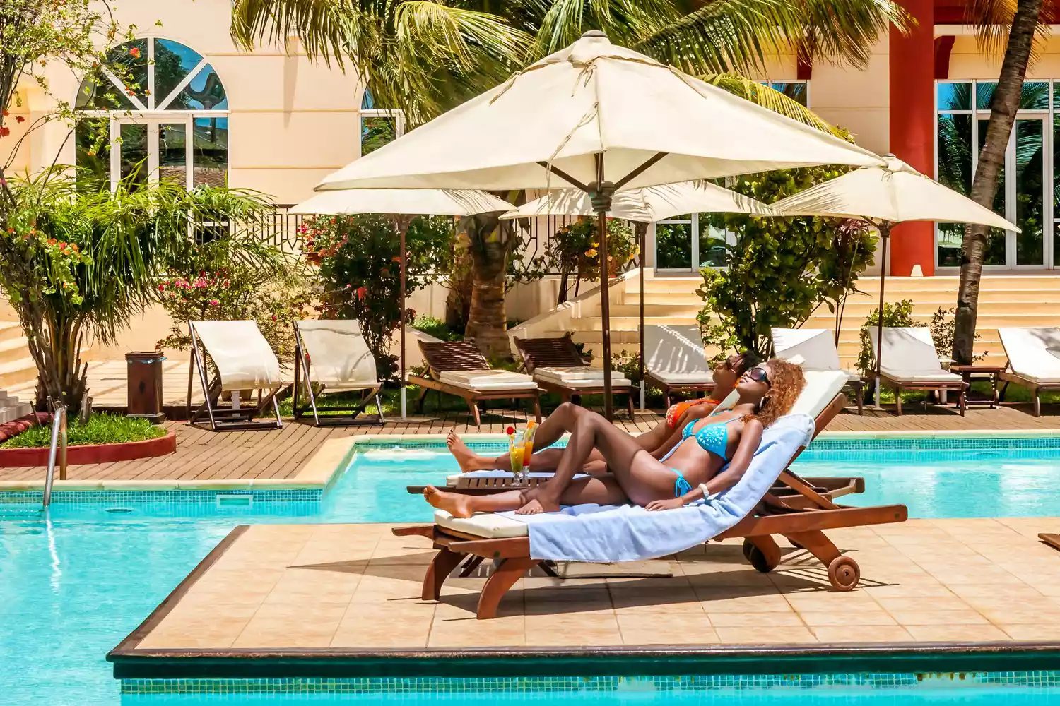 Travelers relaxing at a resort where extra fees may apply