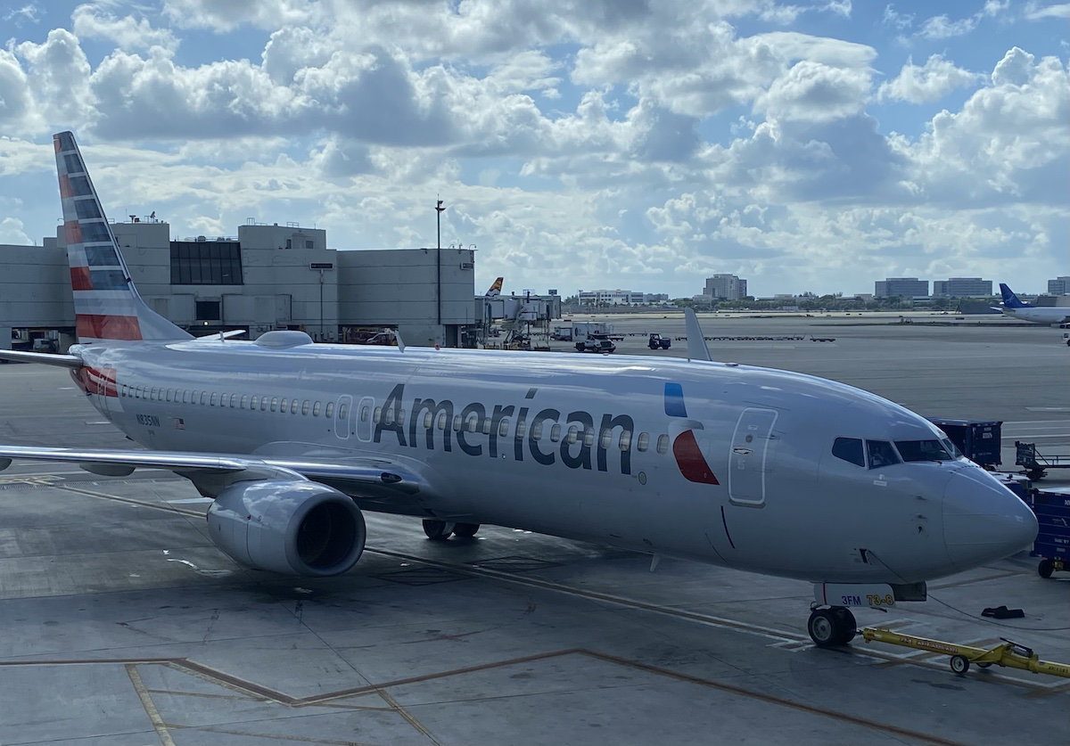 Airline passengers dealing with check-in and potential disruptions at the airport