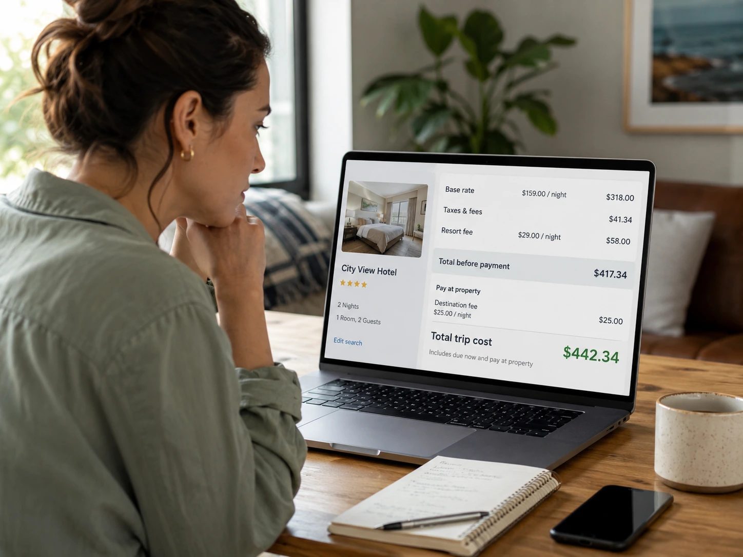 Traveler reviewing hotel booking price details showing base rate, taxes, resort fee, pay-at-property fee, and final trip cost