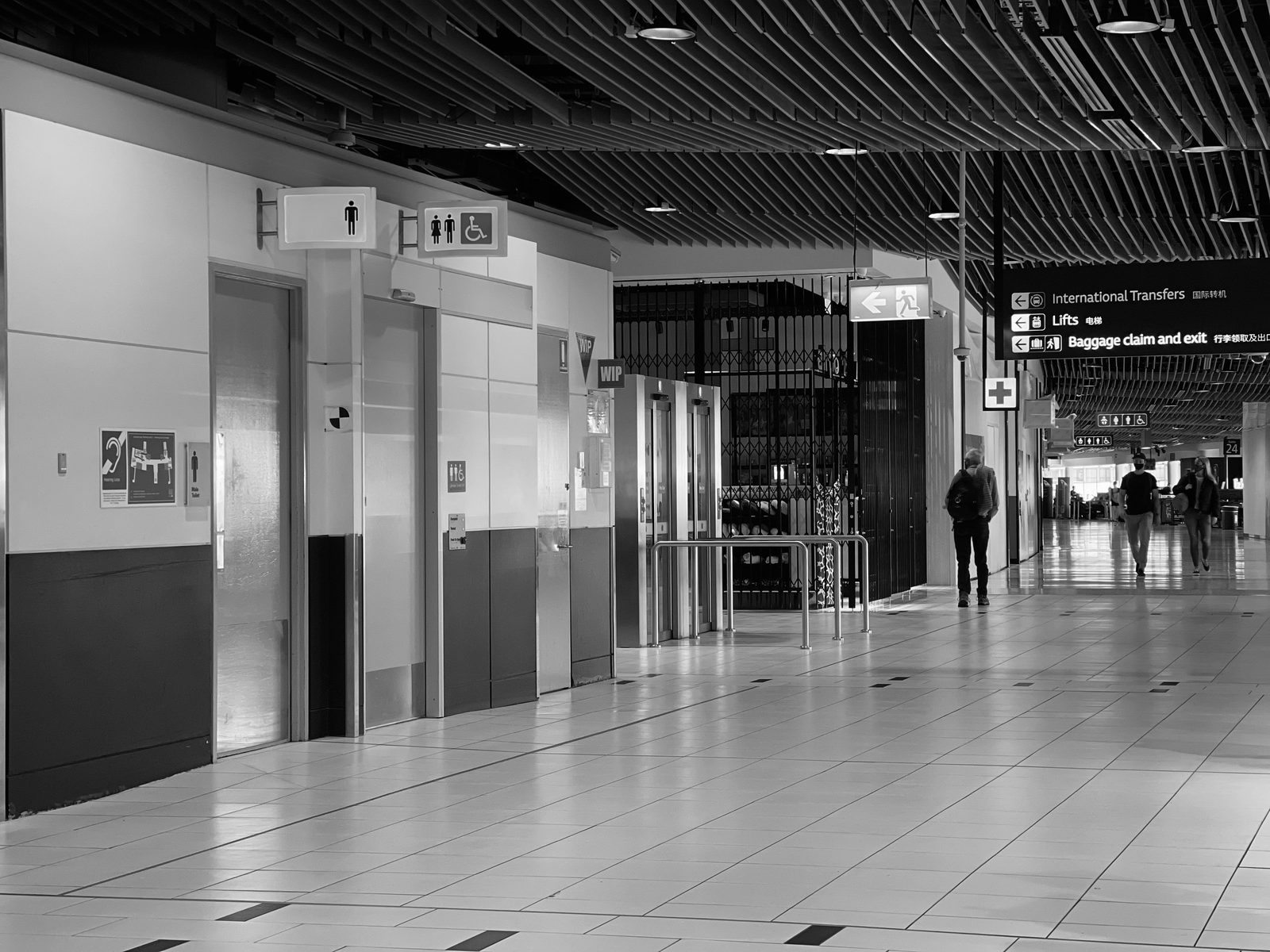 Travelers walking down an airport hallway, illustrating complex itineraries and connections