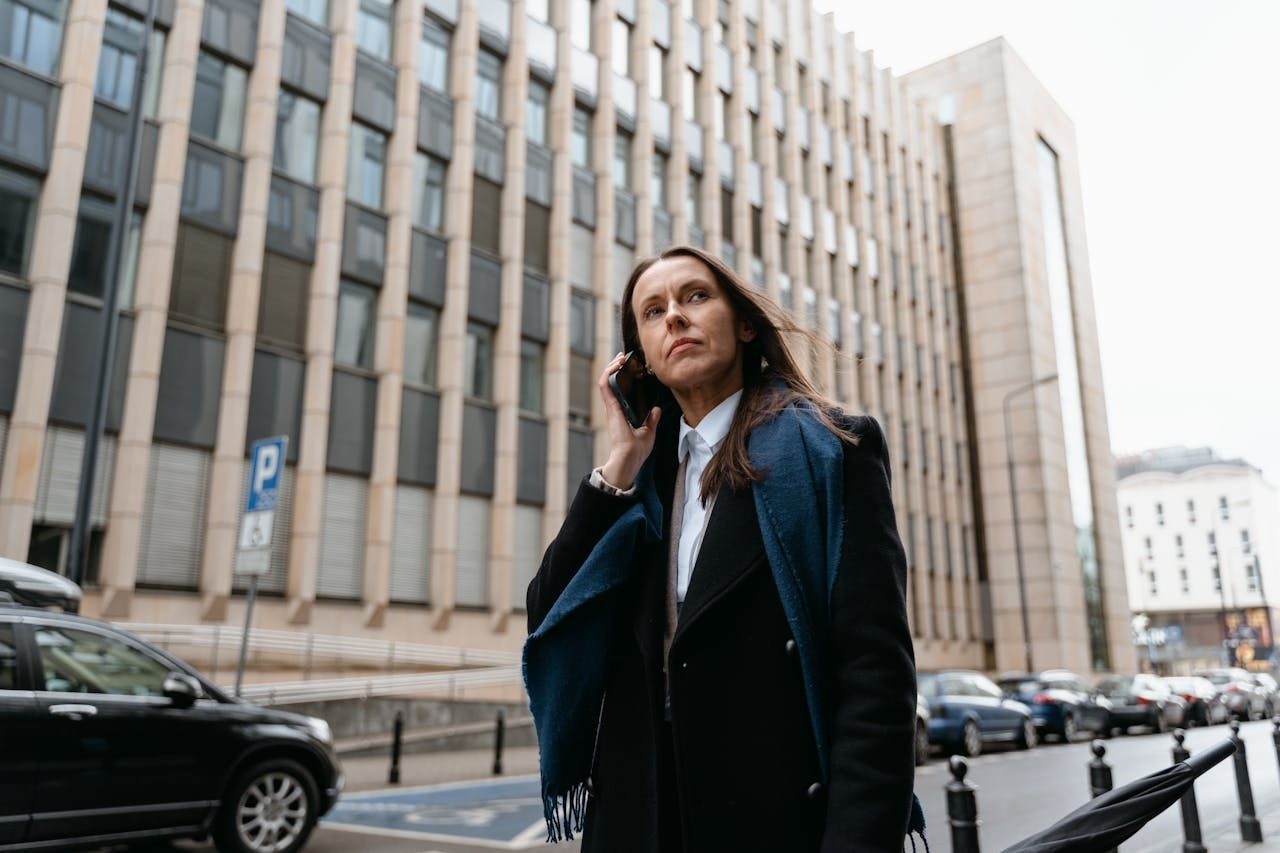 Business woman speaking on her mobile phone while traveling