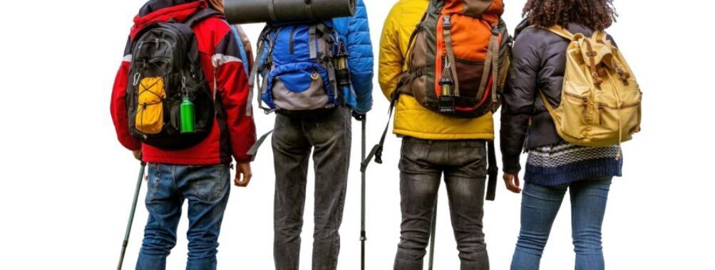 Friends traveling together in winter, walking with luggage, representing shared travel costs and planning.