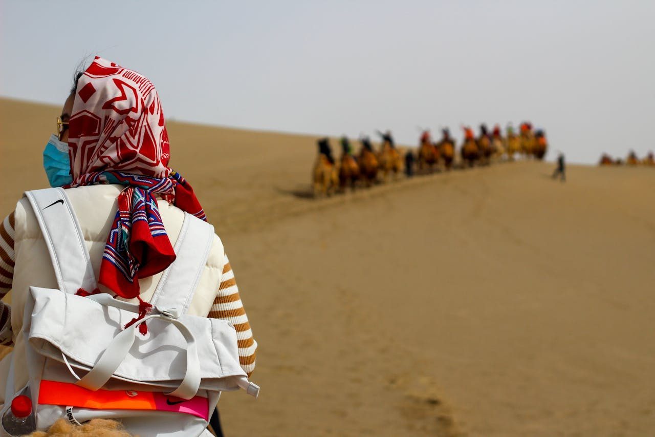 Traveler standing with luggage, suggesting movement and planning during a trip.