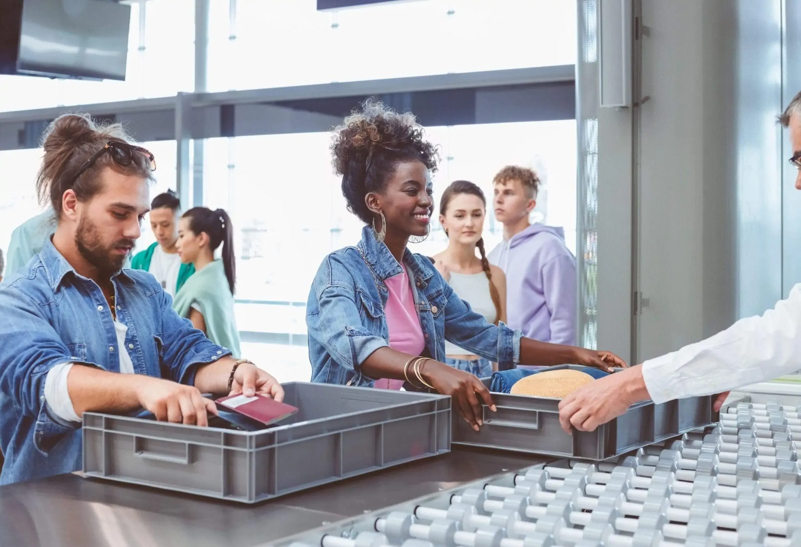 Passengers moving through airport security checkpoint