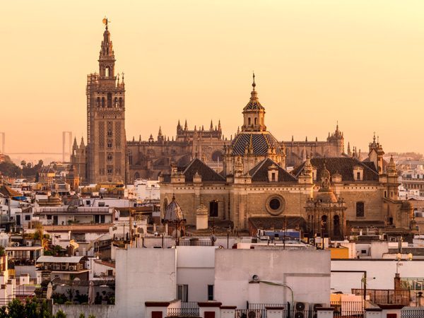 the Seville Cathedral with a sunset backdrop