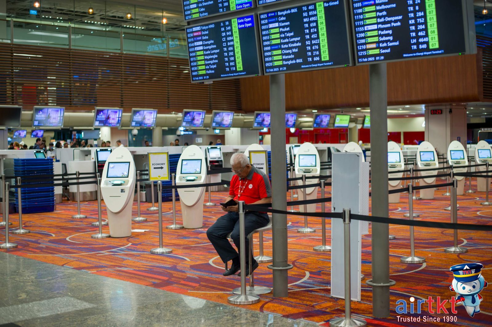 Traveler comparing flight options for multiple airports on a phone in a busy terminal