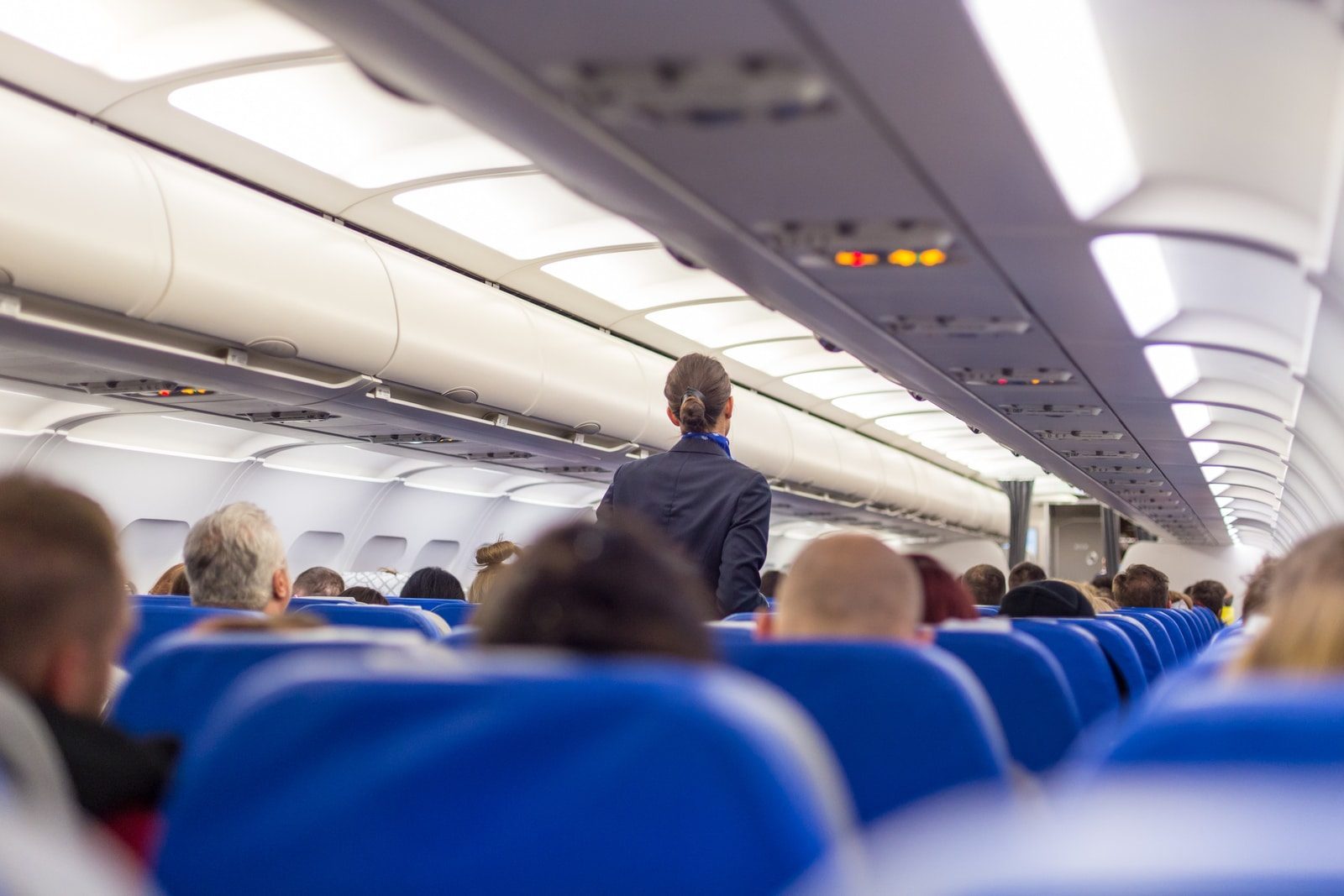 Traveler checking flight details and seat options on a laptop before check-in.