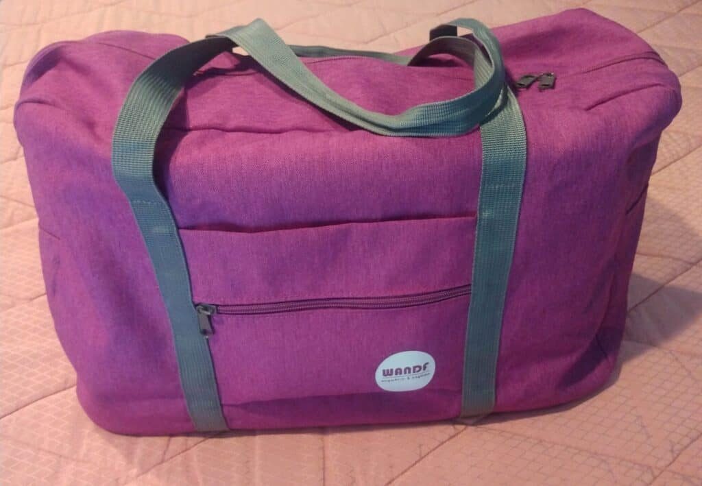 WanderF duffle tote is ideal for a personal item that fits under the seat on a plane.