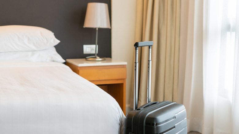 Suitcase in a simple airport hotel room