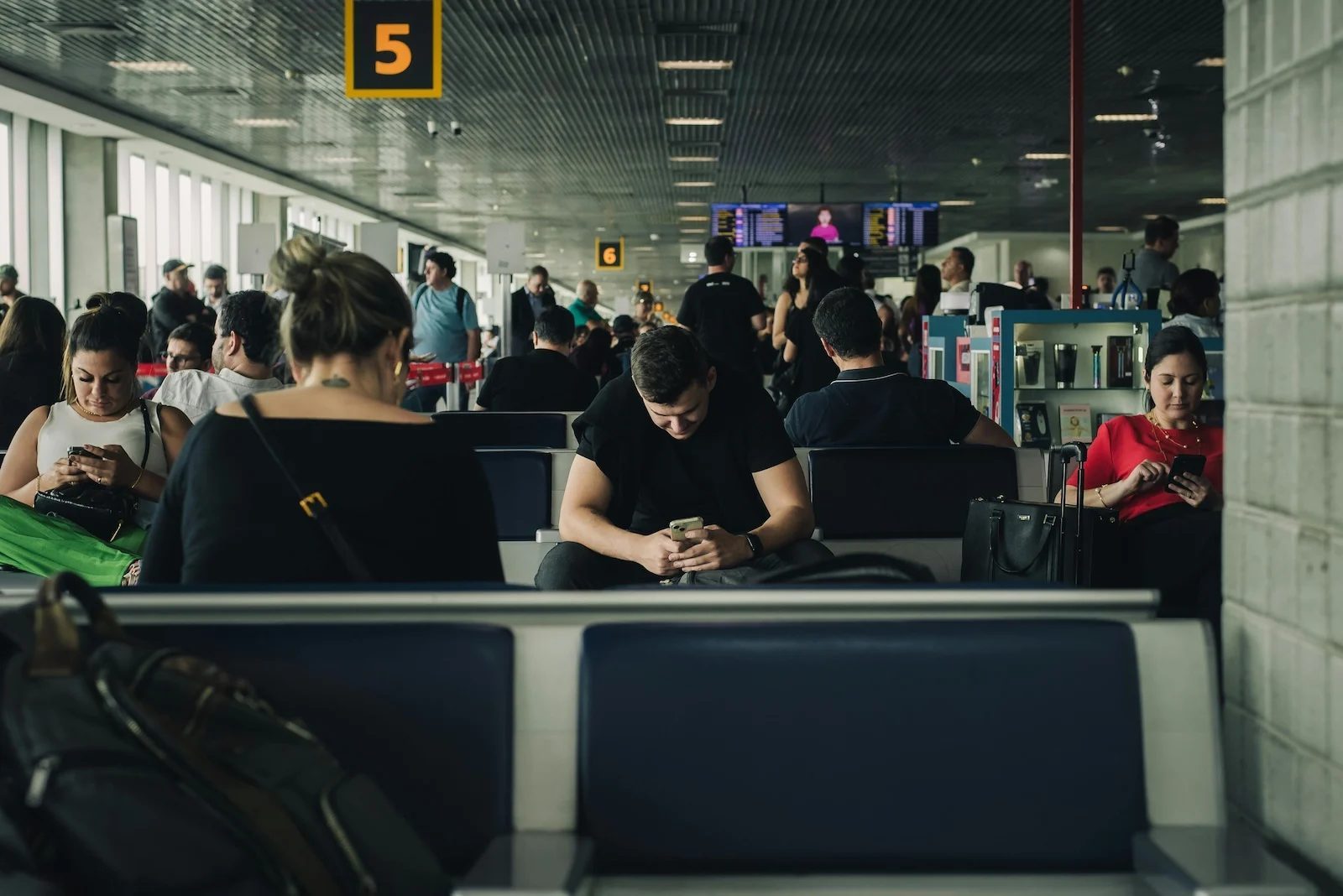 travelers waiting at airport gate during layover