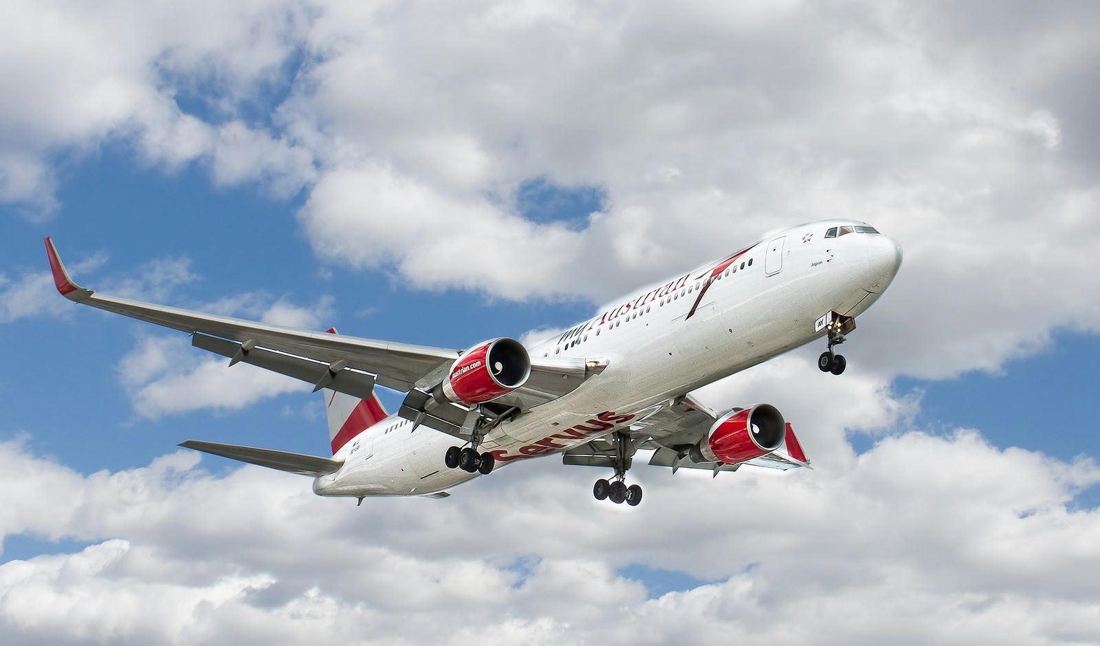 white and red flying airplane under white clouds, Flaps Down Final