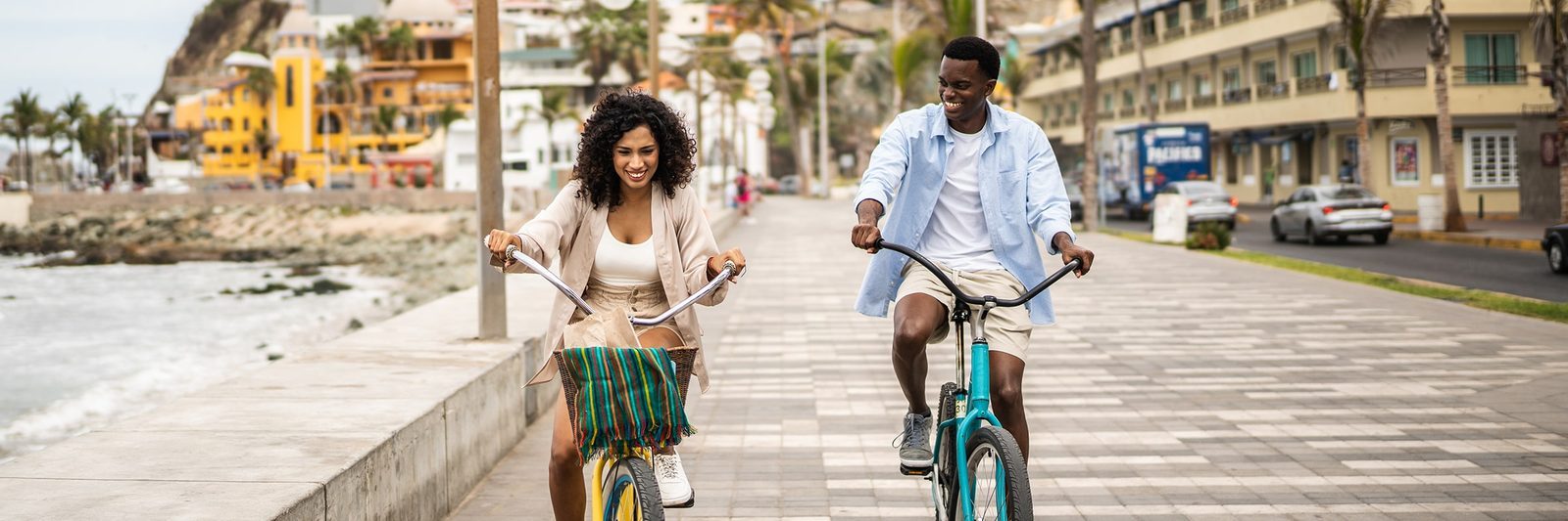 Couple cycling on a boardwalk, representing time and freedom gained by better location choices