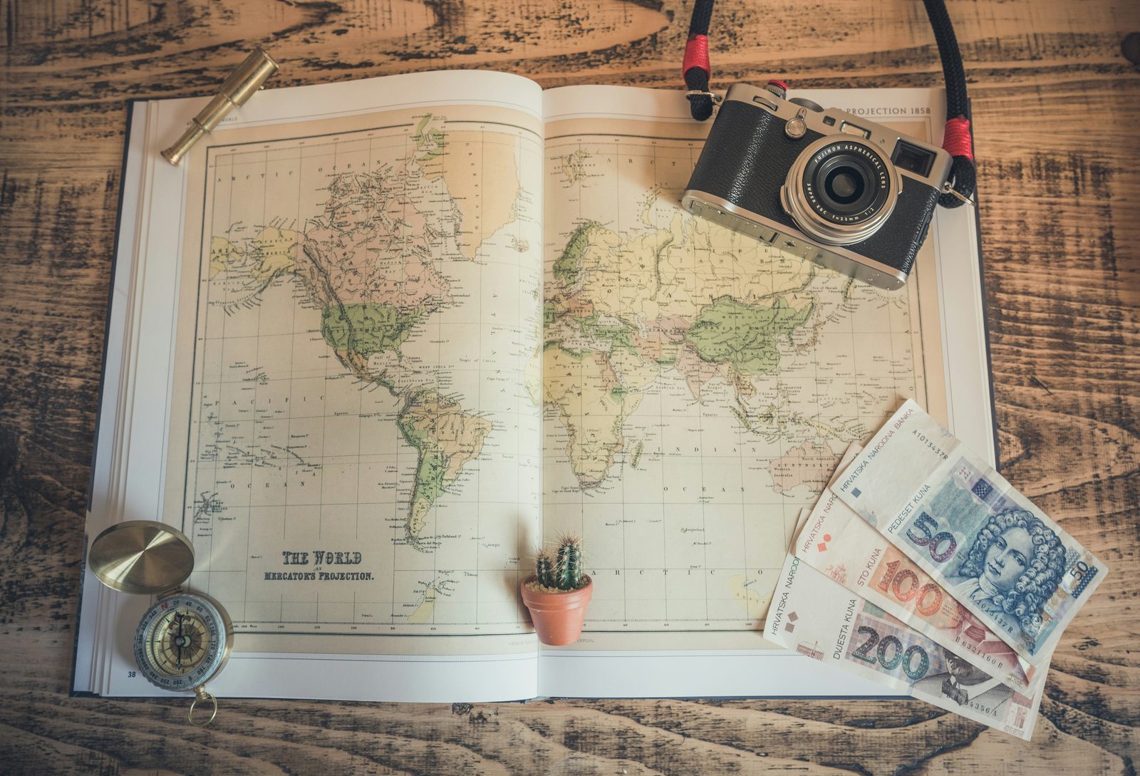 black and silver SLR camera on table, Map compass camera