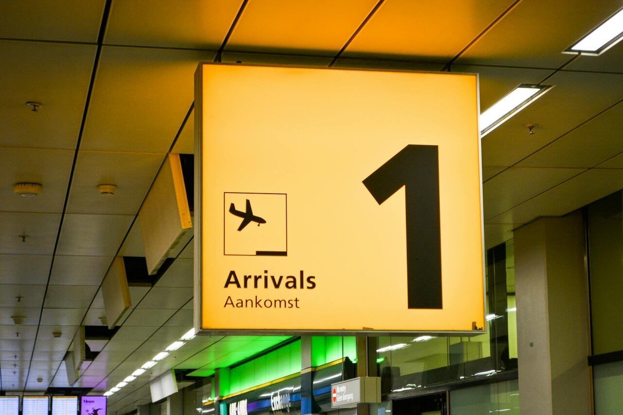 Airport arrivals sign inside terminal for passengers collecting baggage during self transfer