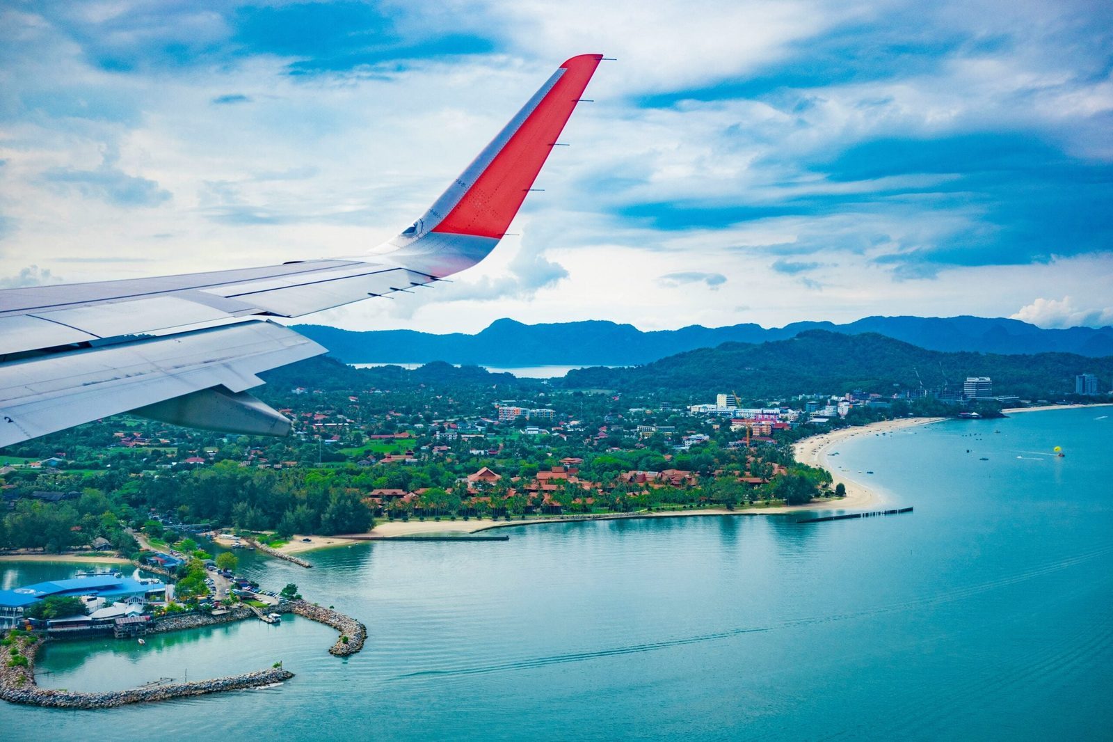 airplane wing shown flying over the Malaysian coast