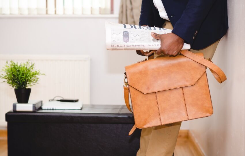 Business Man with a Suitcase and a Newspaper