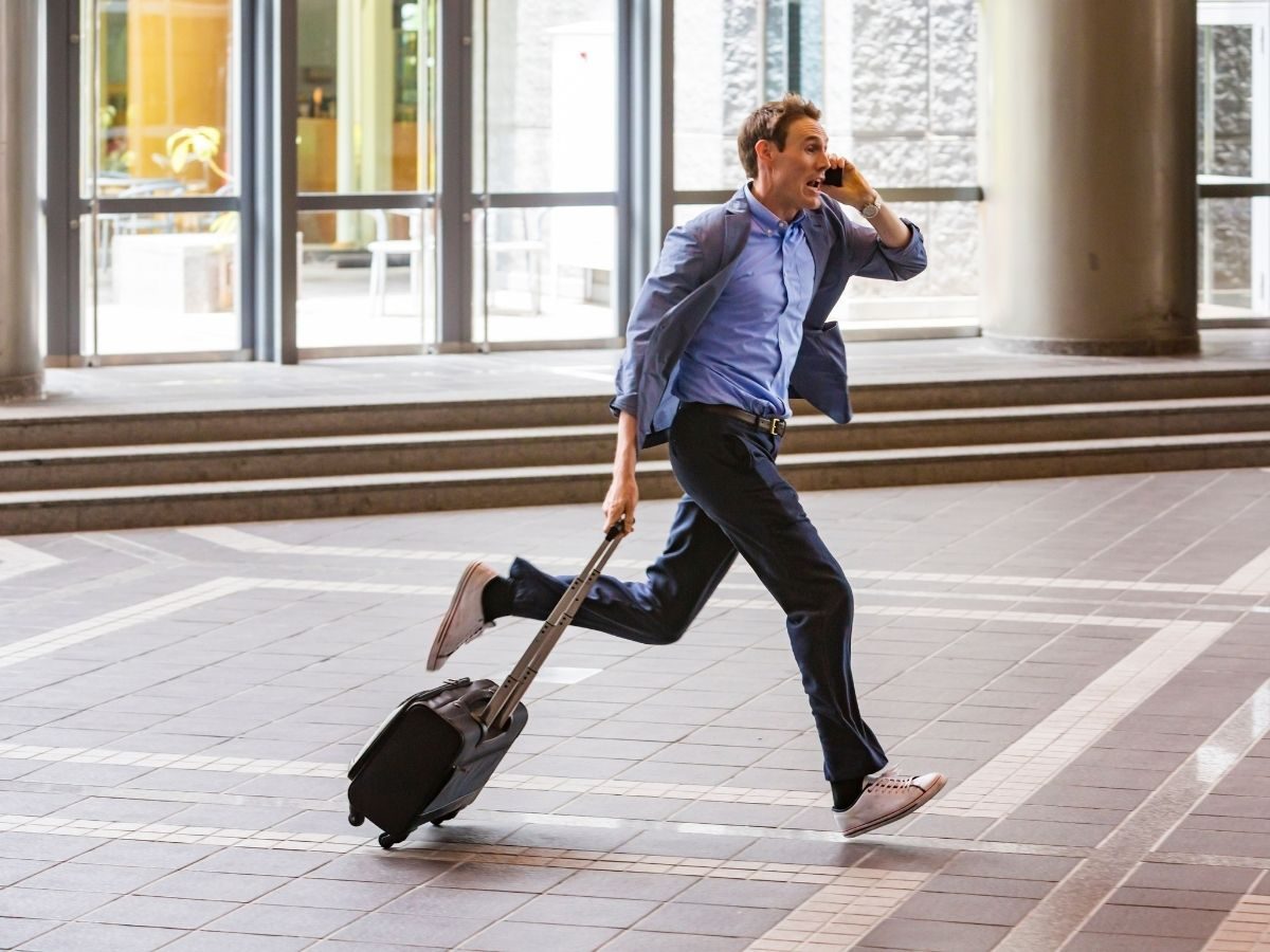 Man running through airport terminal trying to make his flight