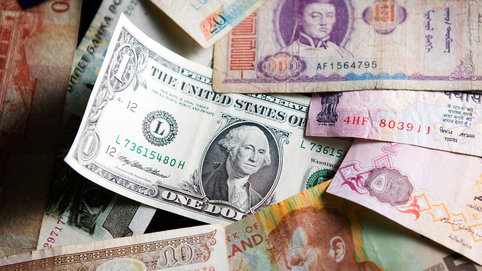 Various international banknotes, including a U.S. dollar, highlighting global currencies and exchange.