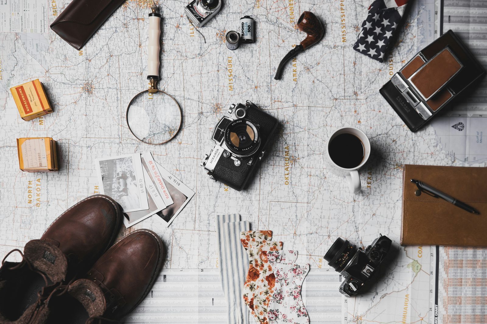 Travel planning essentials laid out on a table