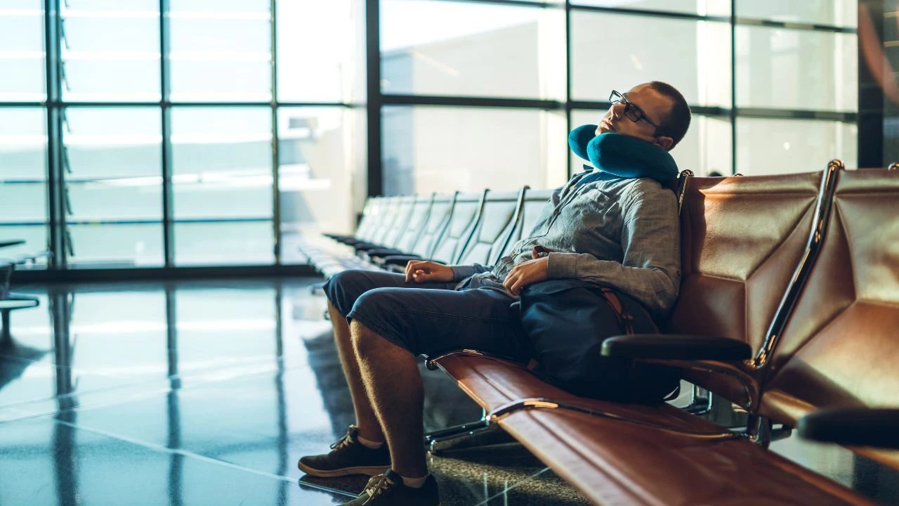 Traveler sleeping upright in an airport terminal