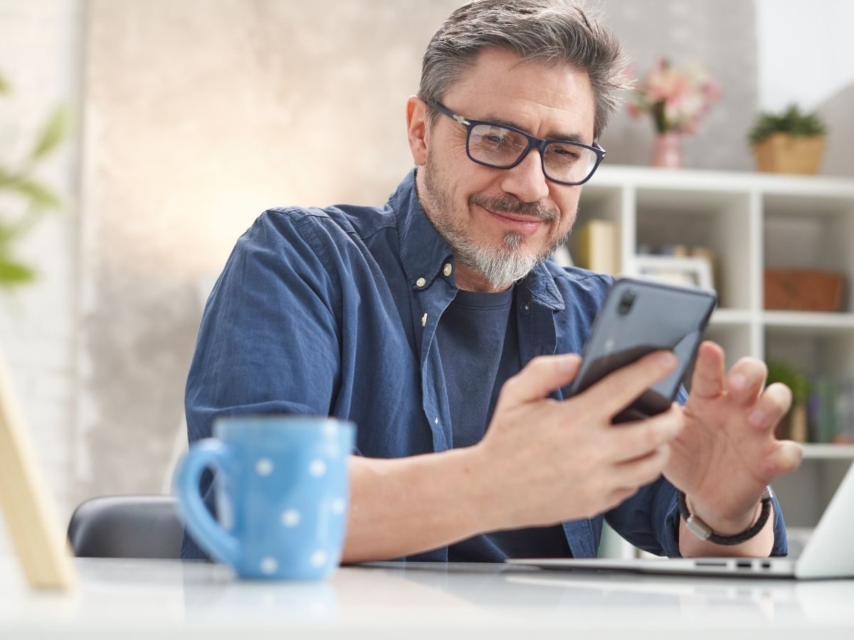 Traveler doing online flight check-in on a laptop with coffee nearby