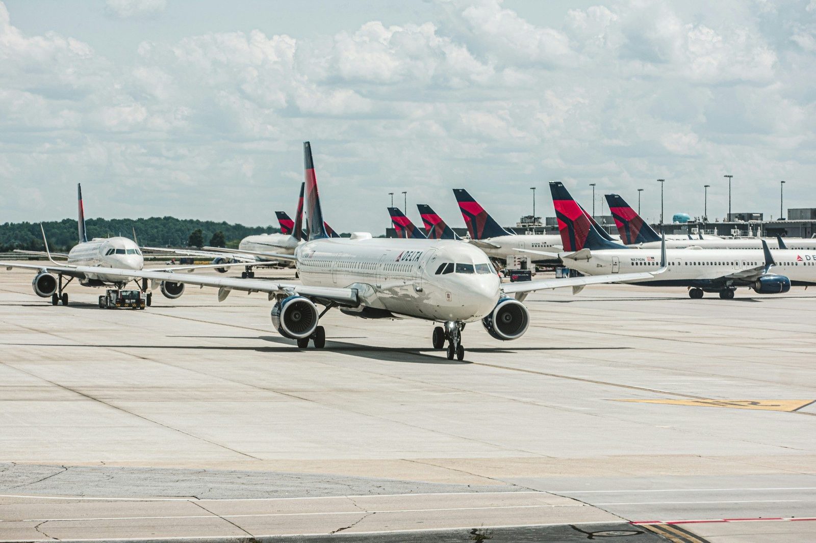 Delta plane at a busy international airport terminal