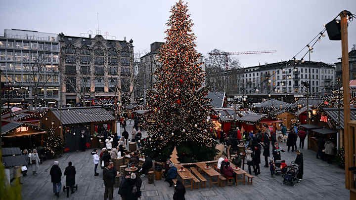 A calm city scene with people walking along a waterfront, illustrating a more relaxed, less crowded travel experience.