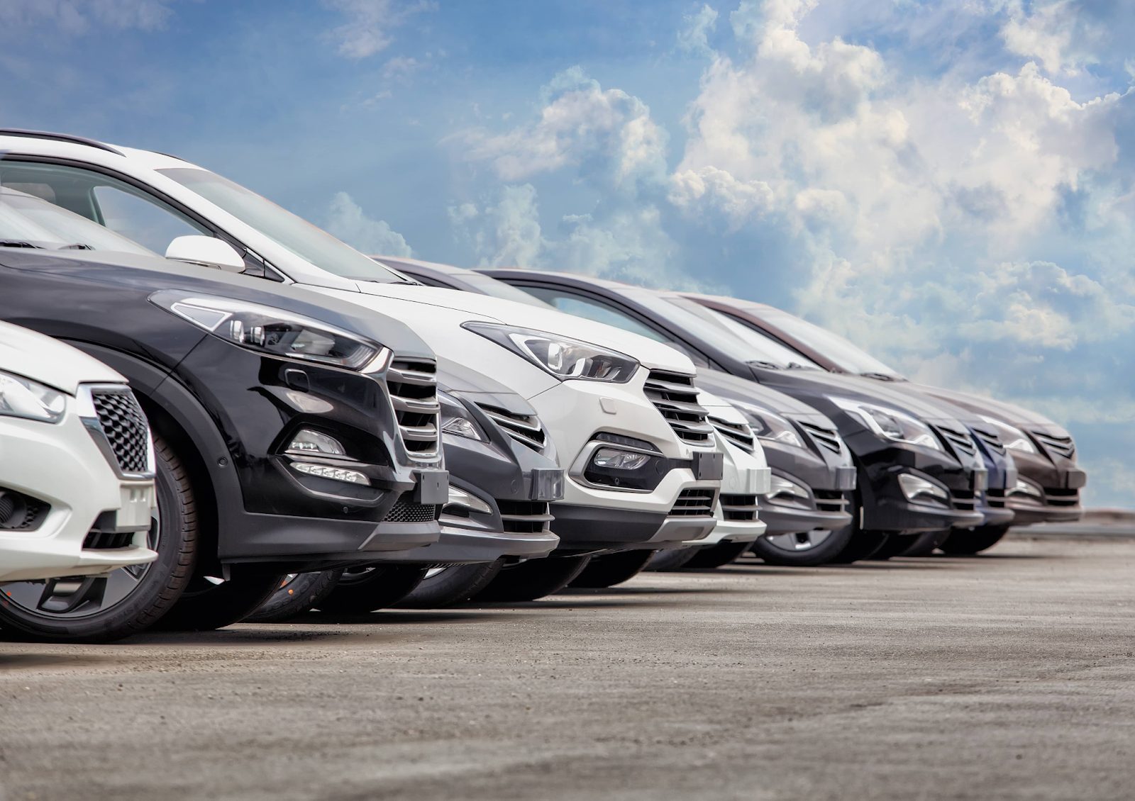 Row of parked cars highlighting transport and parking costs for weekend getaways
