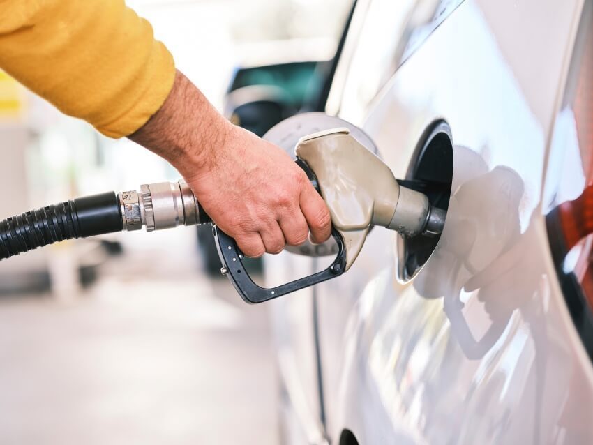 Car being refuelled, symbolising fuel costs affecting flight prices