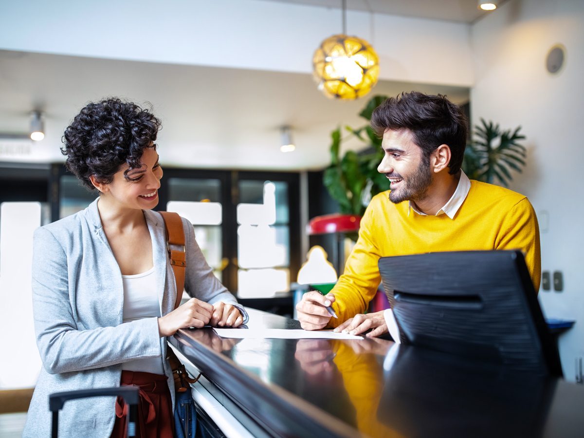 Traveler reviewing hotel bill with added fees